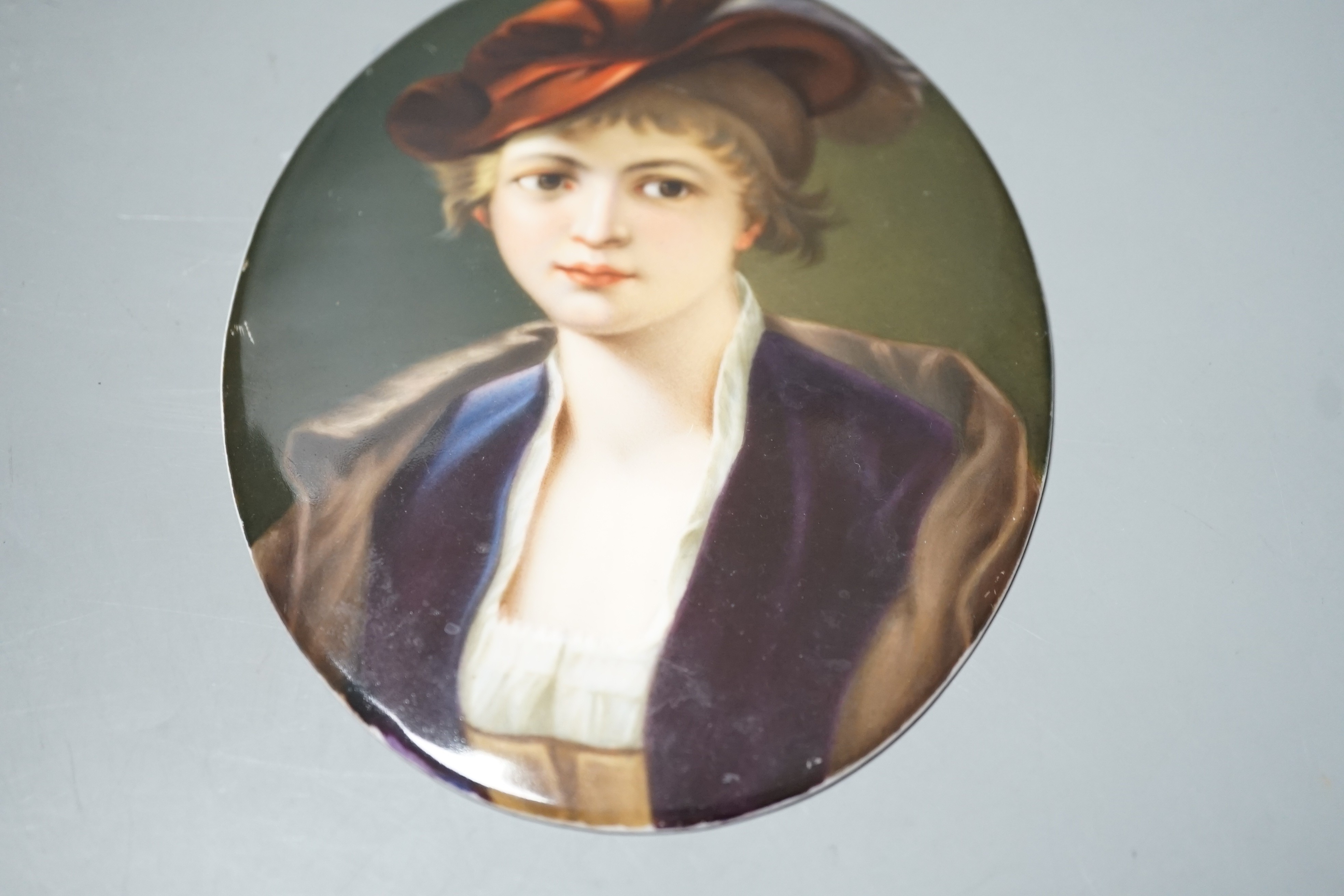 A 19th century oval painted porcelain plaque of a girl, 17 x 13cm